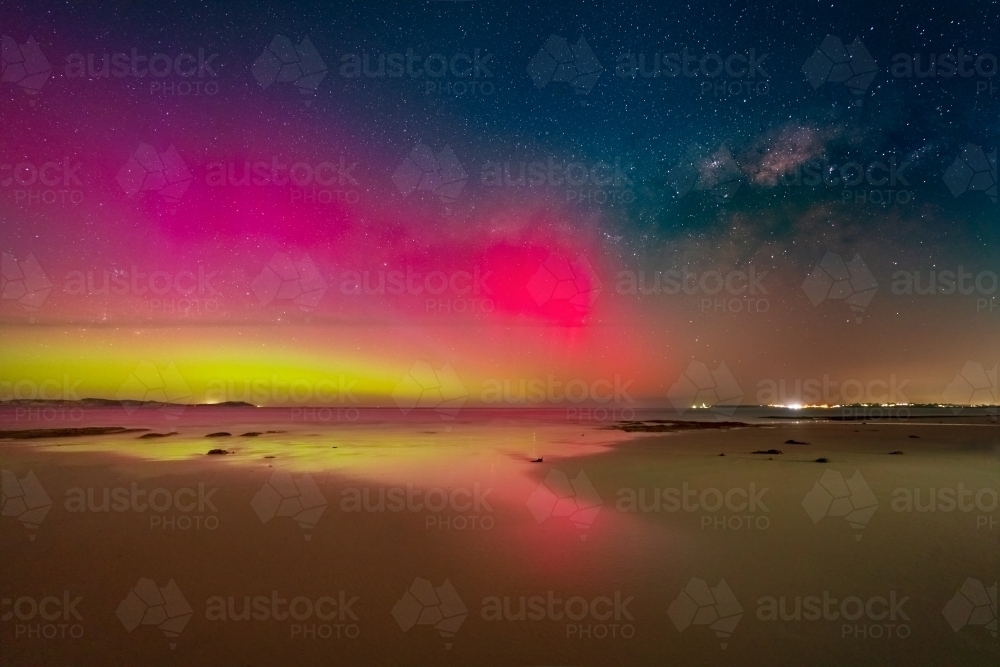 Aurora Australia illuminating the night sky alongside the Milky Way - Australian Stock Image