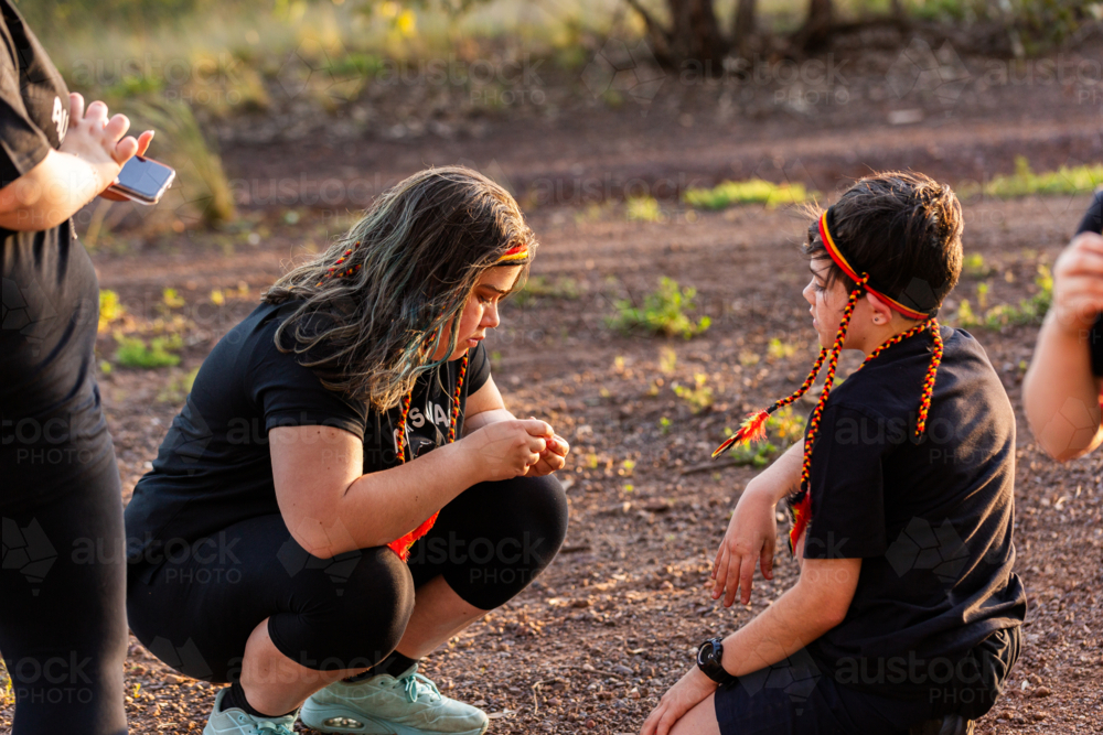 Aussie kids brother and sister chatting together outdoors - Australian Stock Image