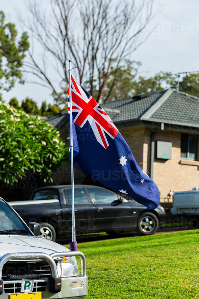 Aussie p plate ute vehicle flying Australian flag for Australia Day showing Aussie pride - Australian Stock Image