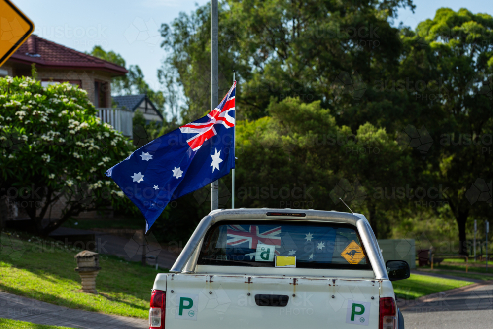 Aussie p plate ute vehicle flying Australian flag for Australia Day showing Aussie pride - Australian Stock Image