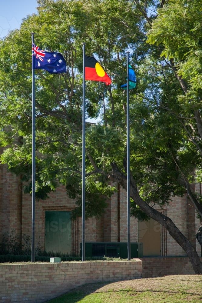 Australian, Aboriginal, and Torres Strait Islander flags flying side by side - Australian Stock Image