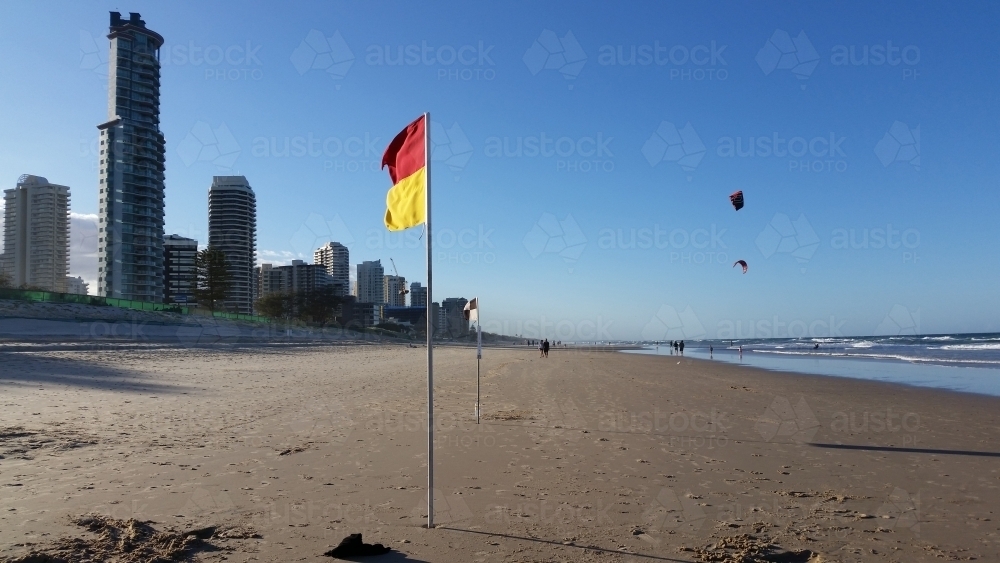 Australian Beach on the Gold Coast with flags and high rise buildings - Australian Stock Image