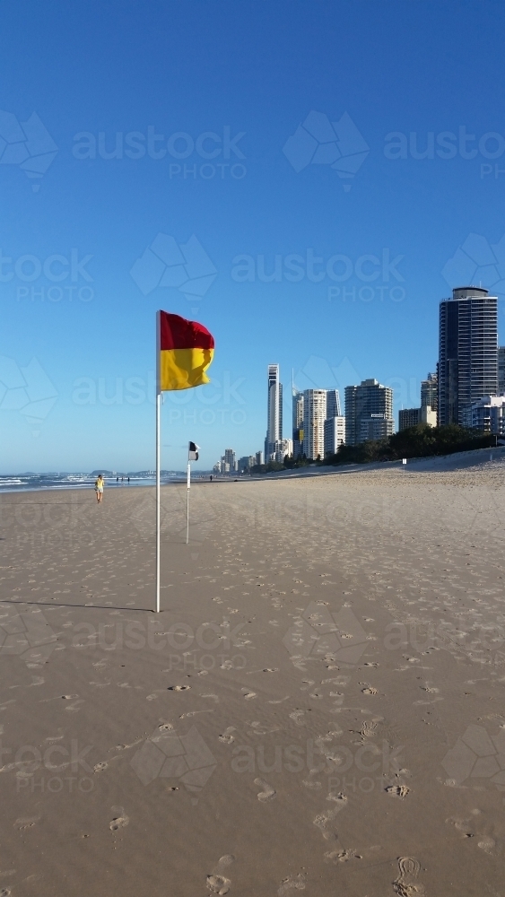 Australian Beach on the Gold Coast with flags and high rise buildings - Australian Stock Image