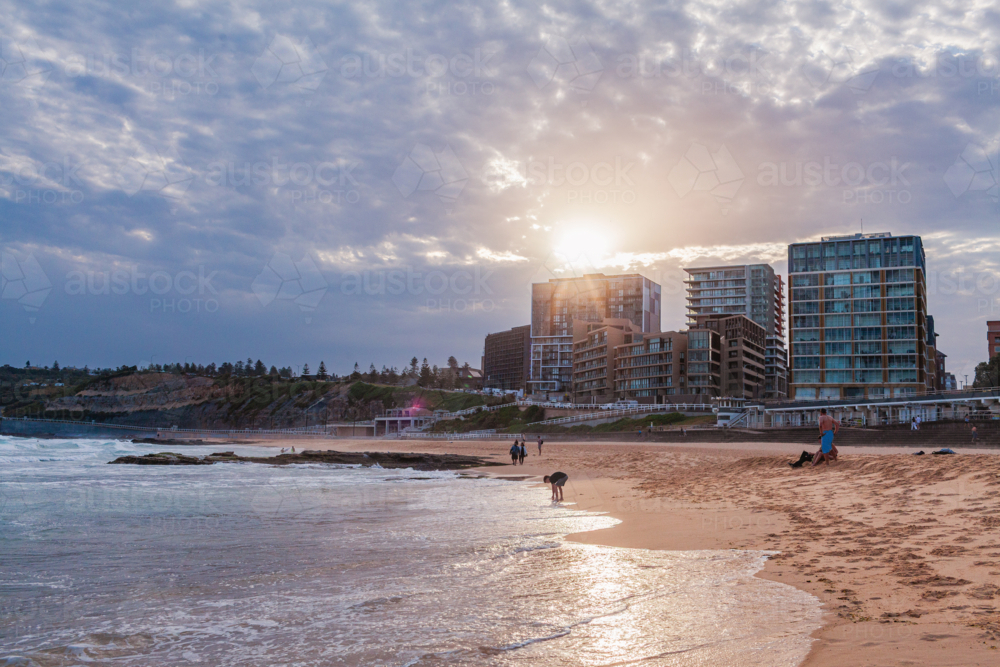 Australian beach scene with sunlight flare over city buildings with waterfront view - Australian Stock Image