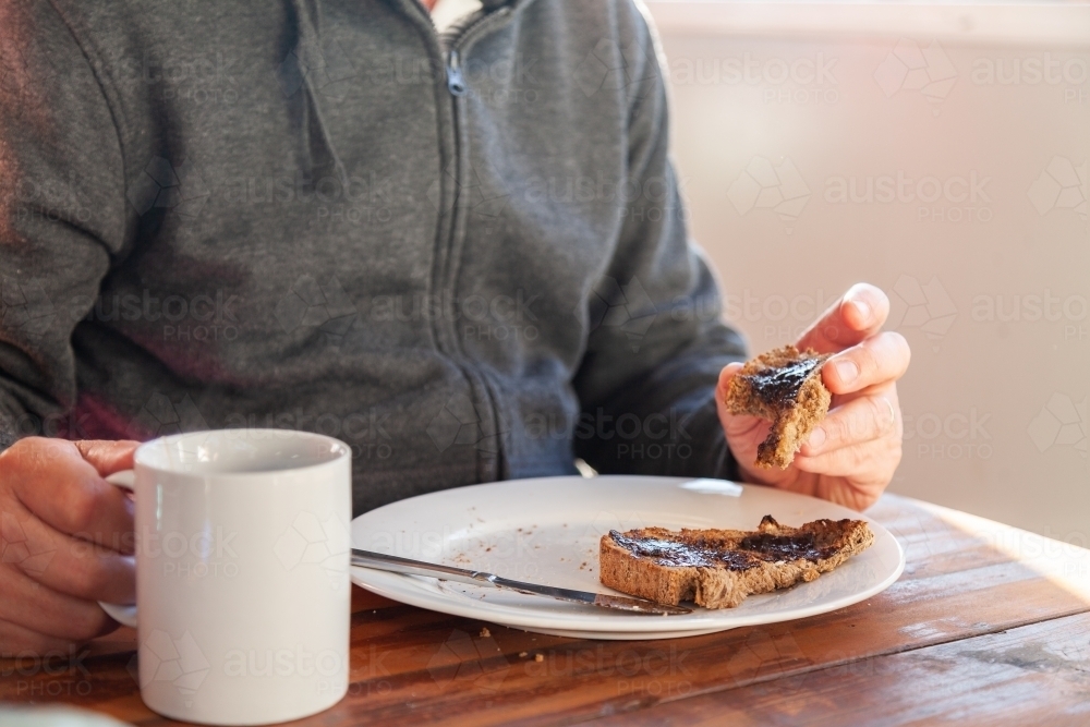 Australian breakfast toast with Vegemite and cup of tea - Australian Stock Image