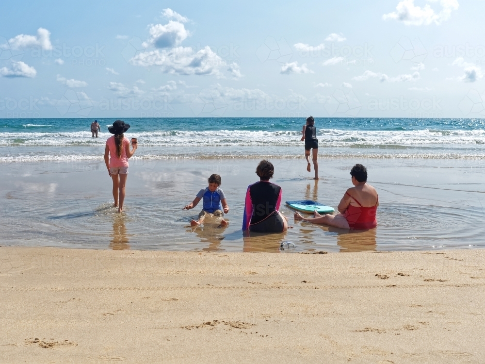 Australian Coastal living with a family enjoying the summer beach, sand and surf - Australian Stock Image