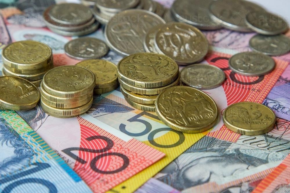 Australian coins sitting on notes - Australian Stock Image