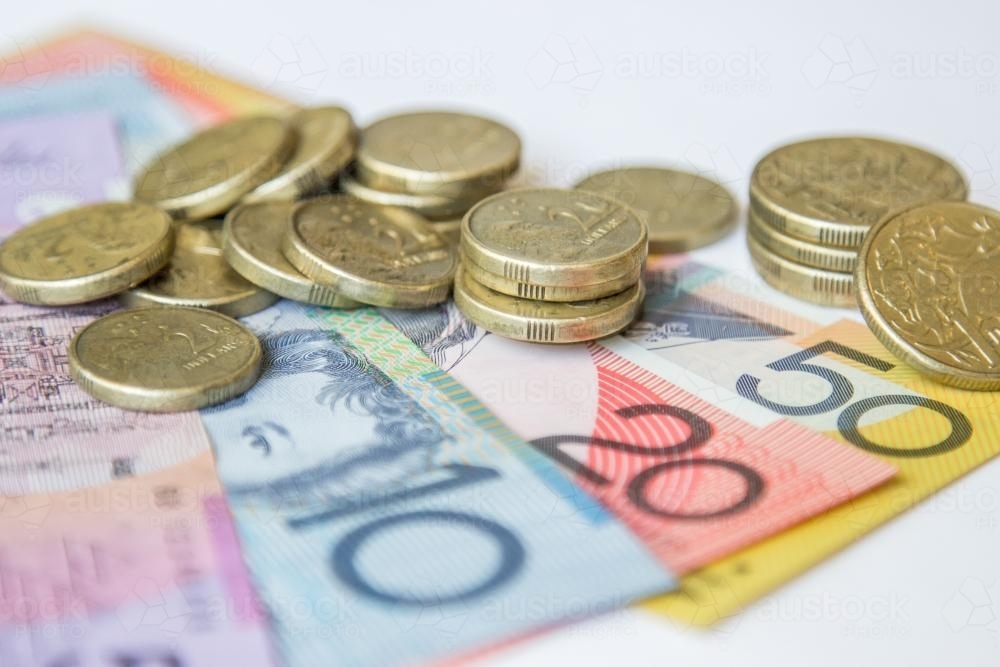 Australian coins sitting on notes - Australian Stock Image