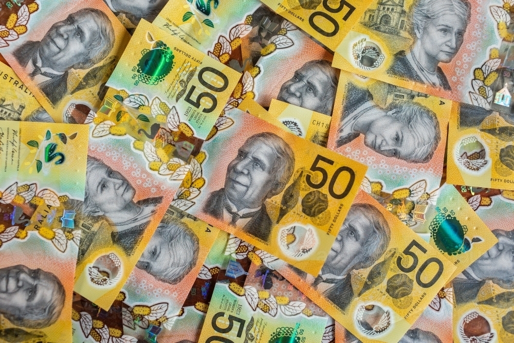 Australian currency - cash of fifty dollar notes scattered and filling frame - Australian Stock Image