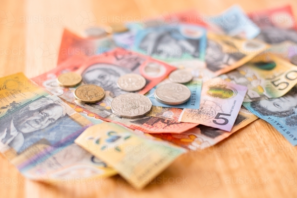 Australian currency with all of the coins on a stack of notes - Australian Stock Image