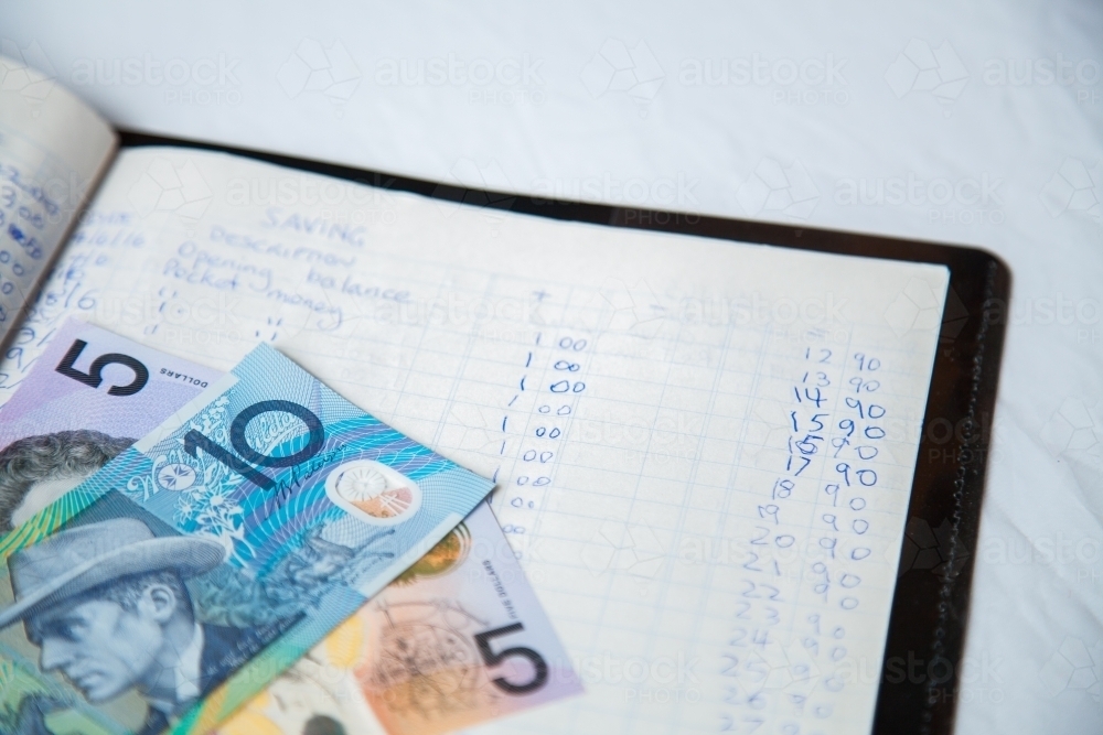 Australian dollar notes on childs budget ledger - Australian Stock Image