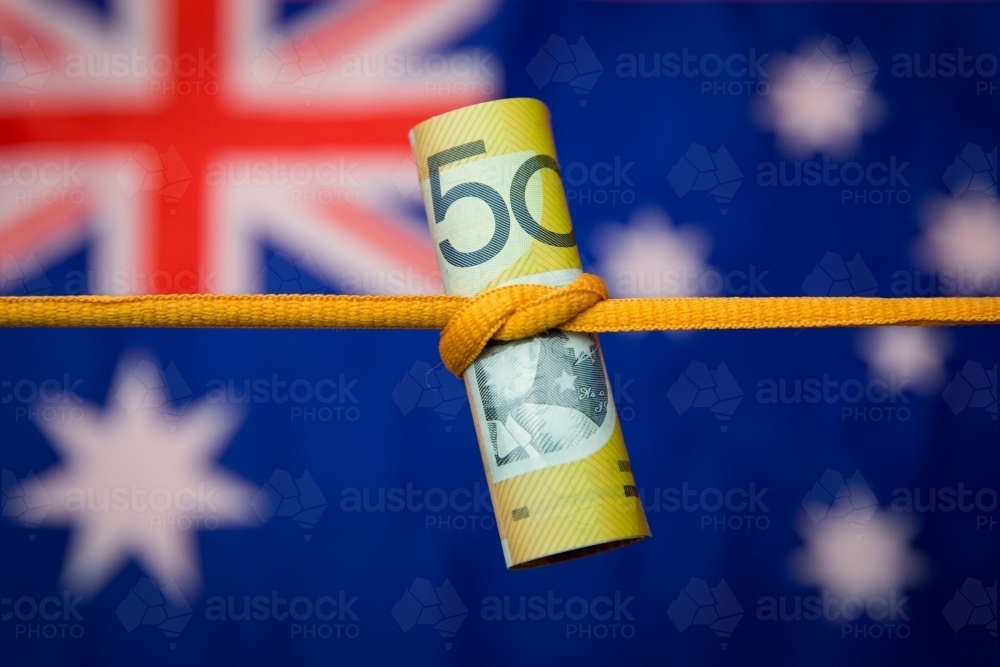 Australian Fifty Dollar Note Tied in a Knot with flag - Australian Stock Image