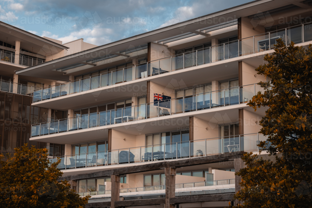 Australian flag displayed on wall of balcony on high rise apartment - Australian Stock Image