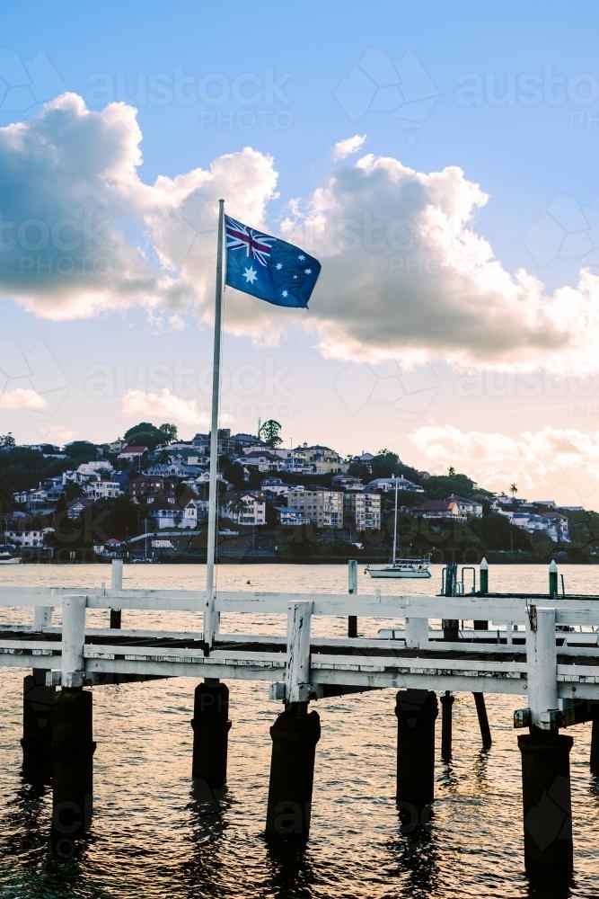 Australian flag flying over a jetty on the Brisbane River - Australian Stock Image