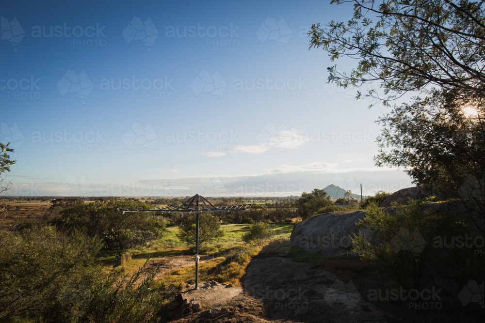 Australian Hills Hoist clothes line in country backyard with rural views - Australian Stock Image