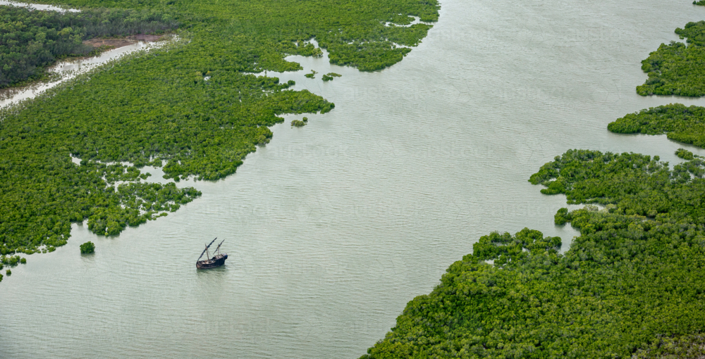 Australian mangrove landscape with boat on waterway - Australian Stock Image