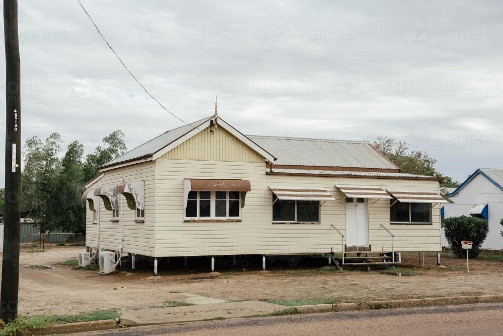 Australian Queenslander cream coloured house with brown trimming - Australian Stock Image