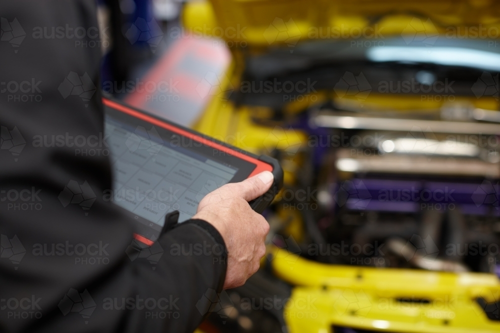 Image of Automotive work on engine of vehicle - Austockphoto