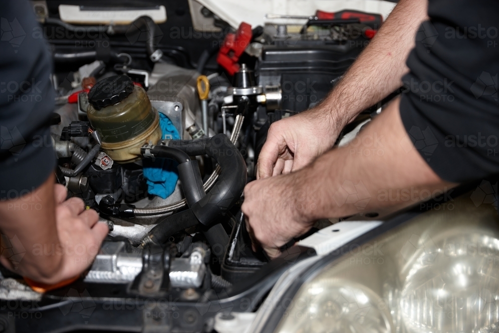Image of Automotive work on engine of vehicle - Austockphoto