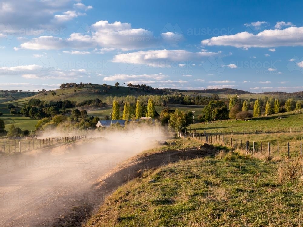 Autumn landscape scene with dust from a passing car - Australian Stock Image