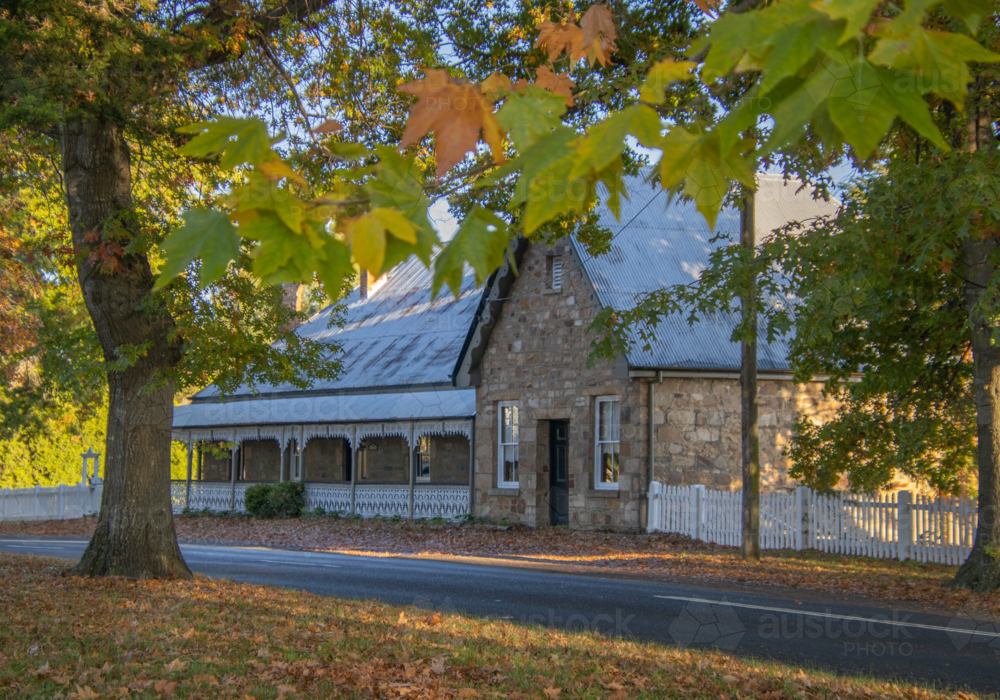 Autumn leaves and a stone cottage - Australian Stock Image
