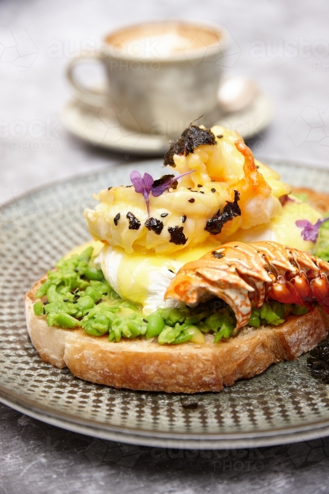 Avocado toast with poached egg and lobster - Australian Stock Image