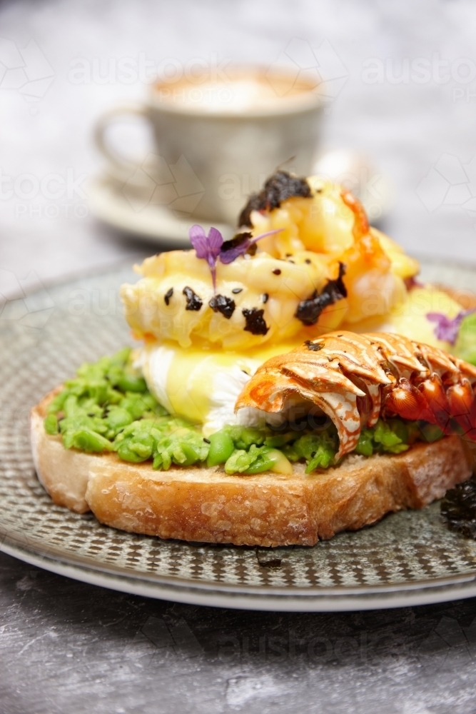 Avocado toast with poached egg and lobster - Australian Stock Image