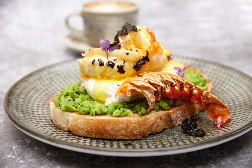 Avocado toast with poached egg and lobster - Australian Stock Image