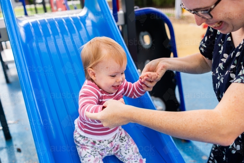 Slippery Dip Ride Image of Baby holding mothers hands to slide down slippery dip at ...