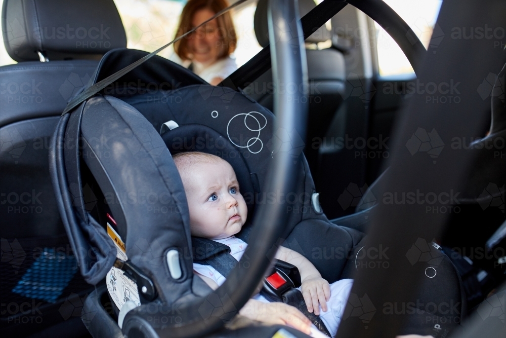 Baby in rear facing car seat - Australian Stock Image