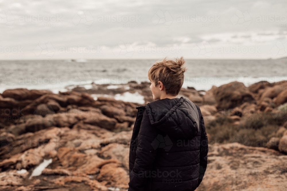 back shot of a boy on a windy day - Australian Stock Image