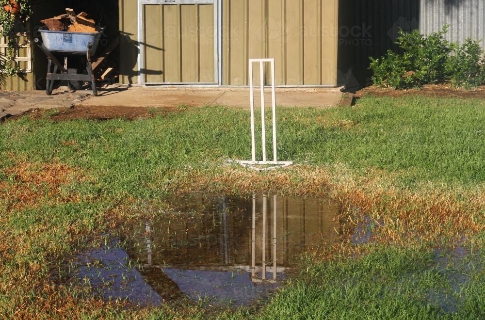 Backyard cricket - Too wet for play - Australian Stock Image