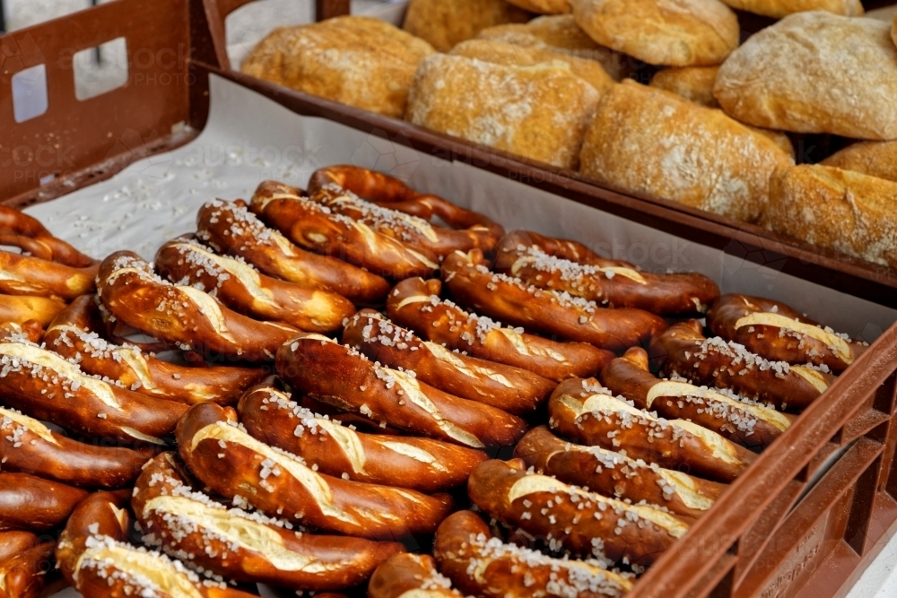 Baked goods and salty crust pretzels for sale at farmers Sunday markets - Australian Stock Image