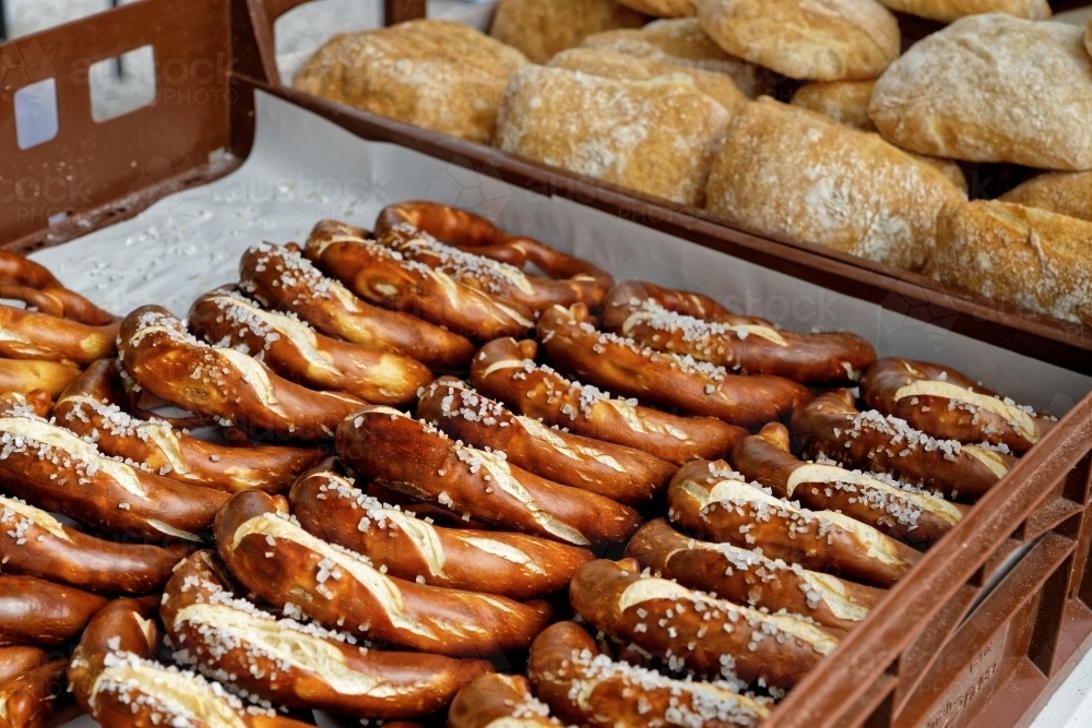Baked goods for sale at market stall, salty pretzel or bagel - Australian Stock Image