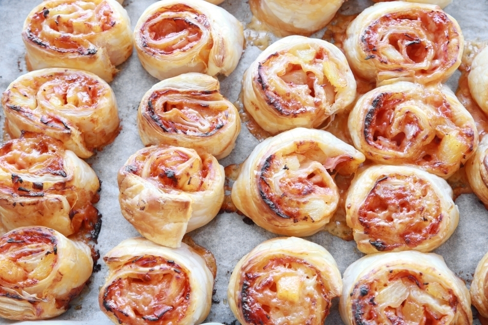 Baked Hawaiian pizza rolls - Australian Stock Image