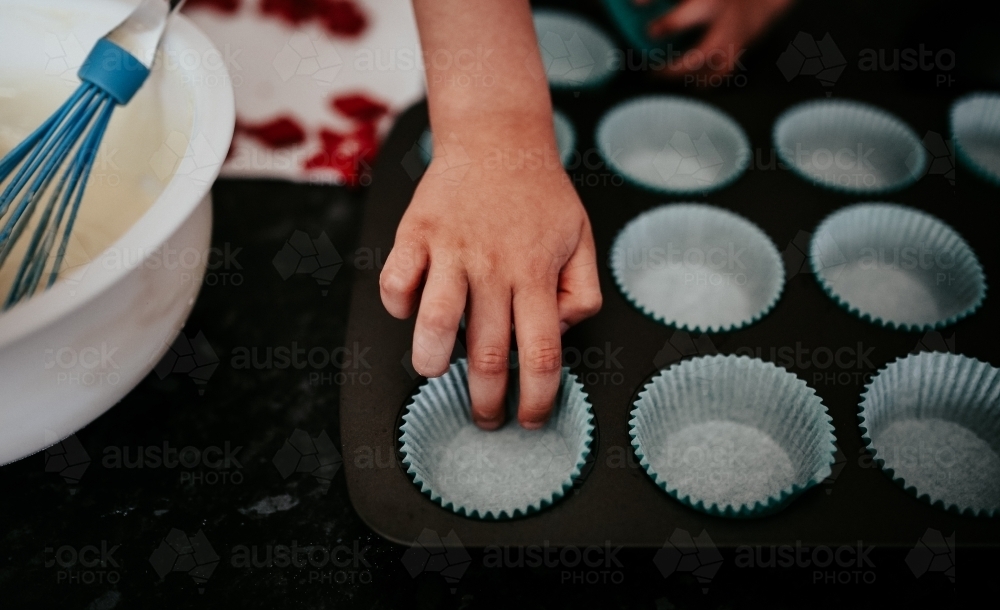 Baking cup cakes with a toddler - Australian Stock Image