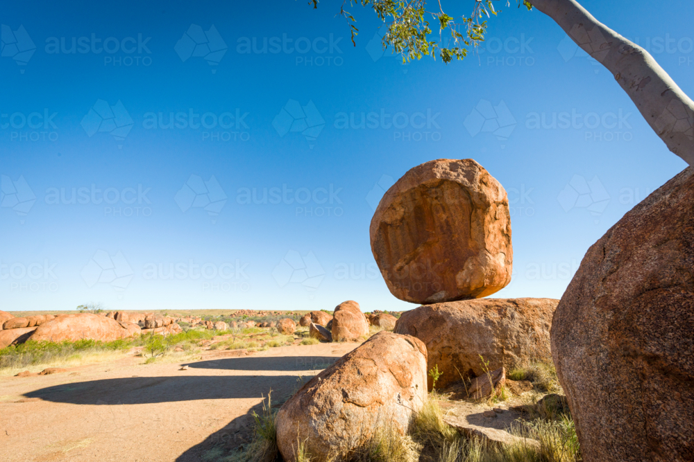 Balancing boulder at the Devils Marbles. - Australian Stock Image