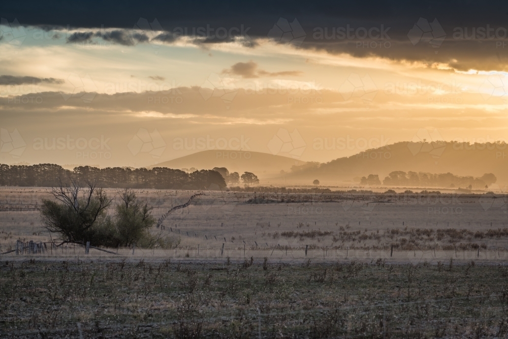 Ballarat region sunset over dry paddock - Australian Stock Image