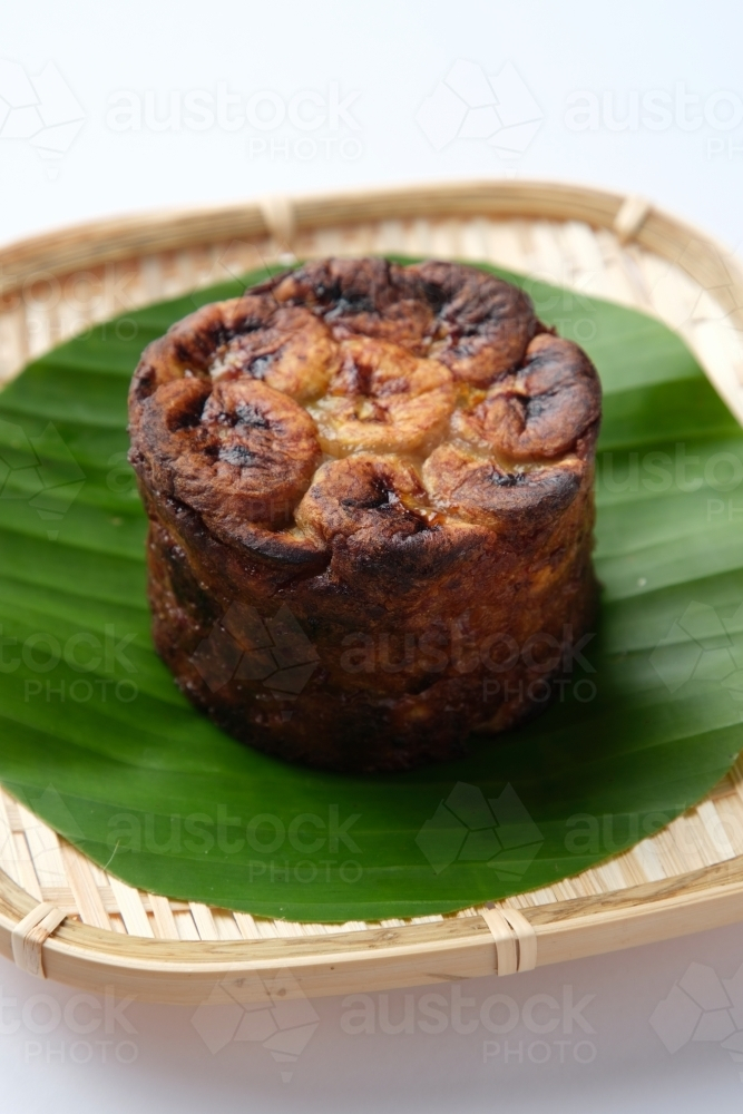 Banh Chuoi Nuong served on a banana leaf in a woven plate. - Australian Stock Image