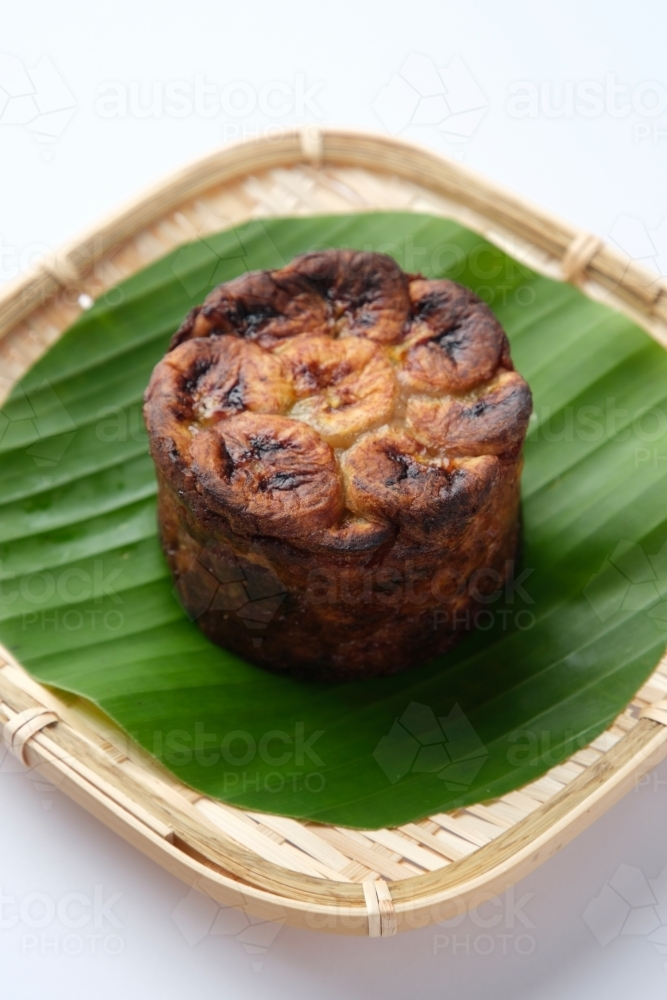 Banh Chuoi Nuong served on a banana leaf in a woven plate. - Australian Stock Image