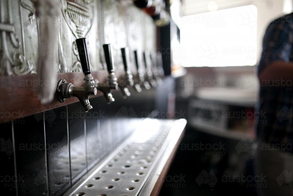 Bar taps behind bar at a local craft beer pub - Australian Stock Image