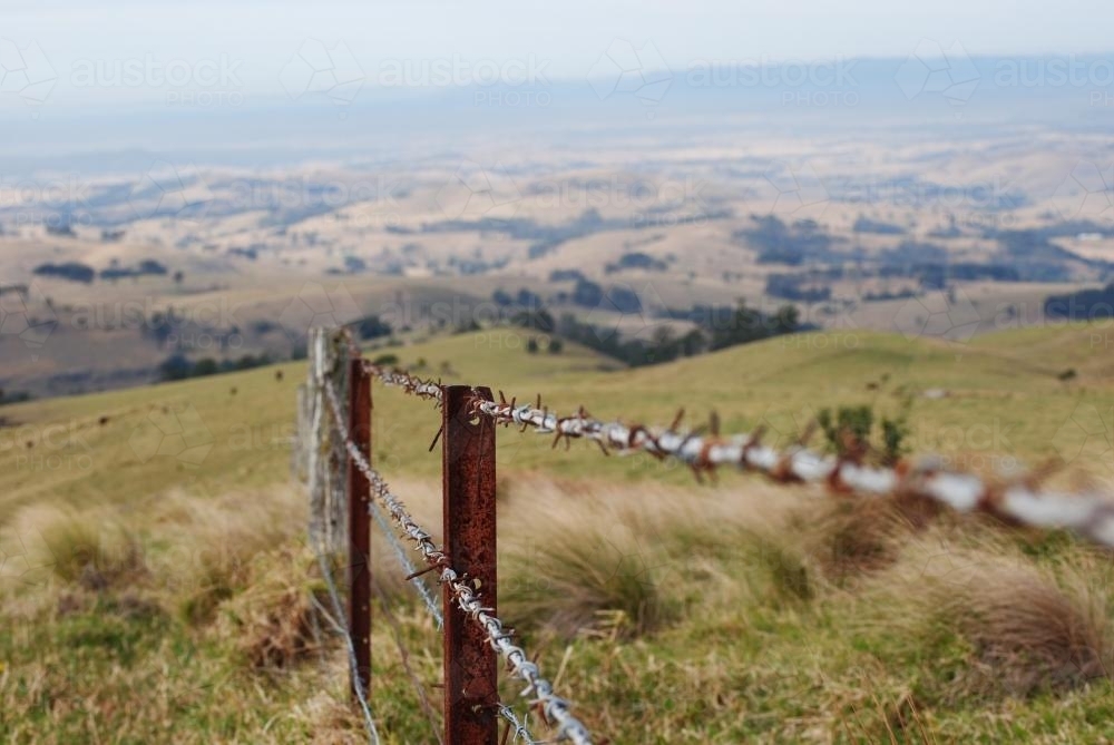 Barbed wire fence in the mountains - Australian Stock Image