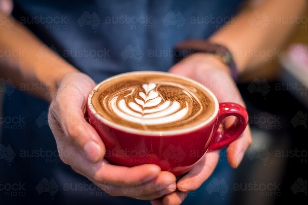 Barista holding coffee - Australian Stock Image