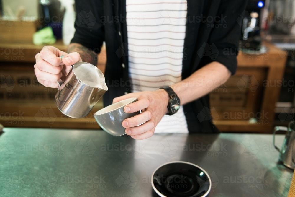 Barista making coffee inside a cafe - Australian Stock Image