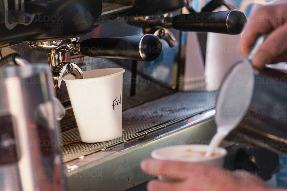 Barista pouring takeaway flat white coffee - Australian Stock Image