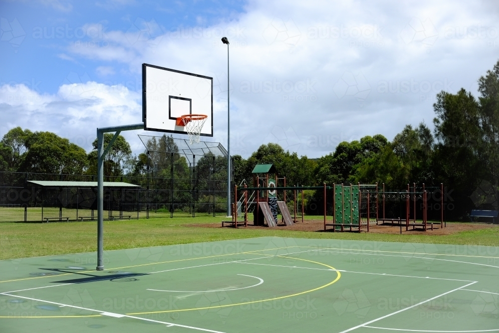 Image of Basketball Court with Kids Playground - Austockphoto