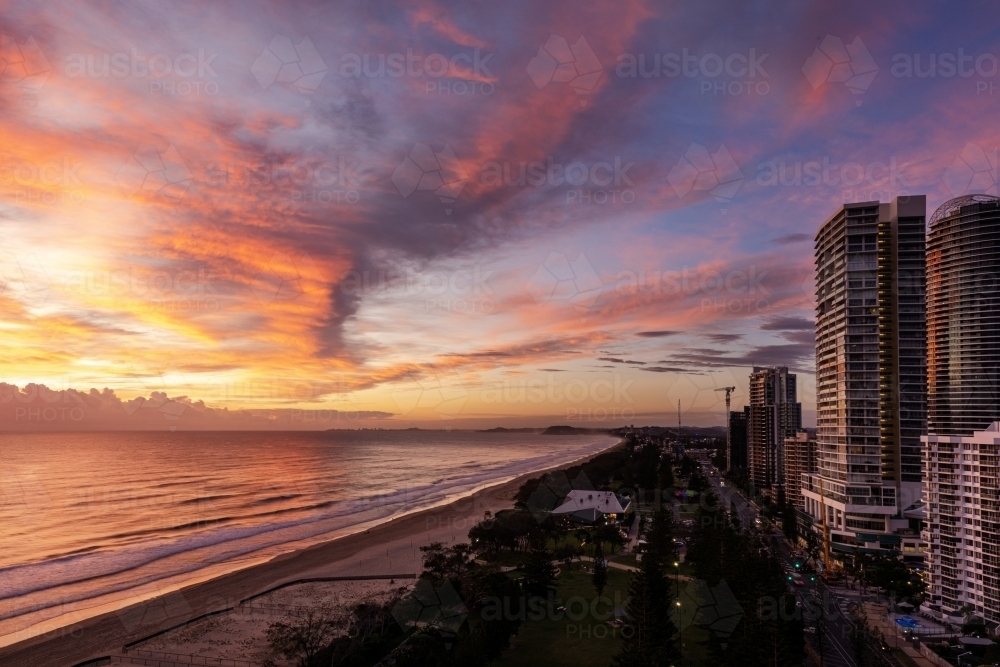 beach and high rise buildings at sunrise - Australian Stock Image