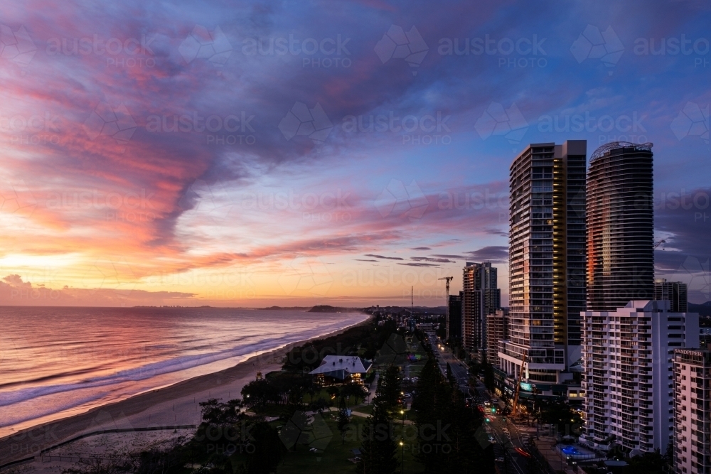 beach and high rise buildings at sunrise - Australian Stock Image