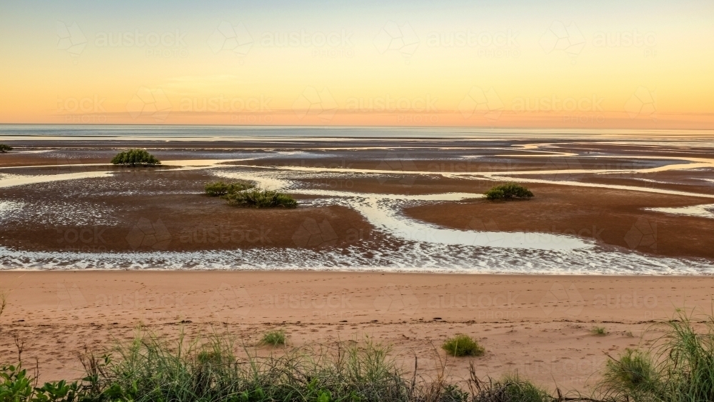Beach and tidal mud flats at sunset - Australian Stock Image