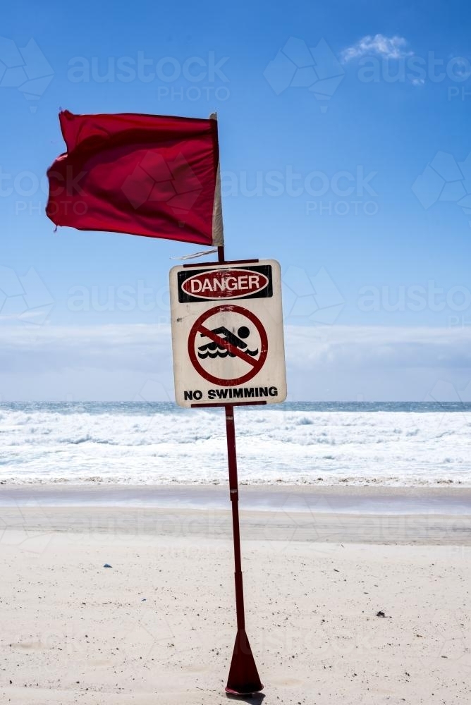 Beach closed sign in front of rough white water on the Gold Coast - Australian Stock Image